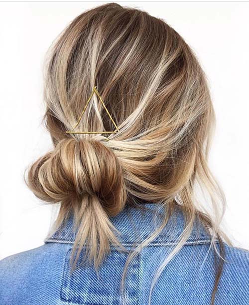 Accented messy bun hairstyle for long thin hair