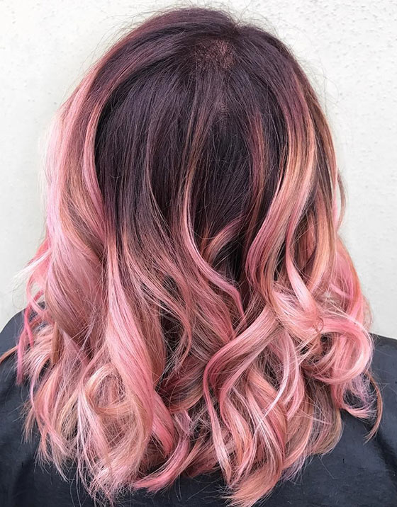 A sweet blush pink ombre on medium length curls