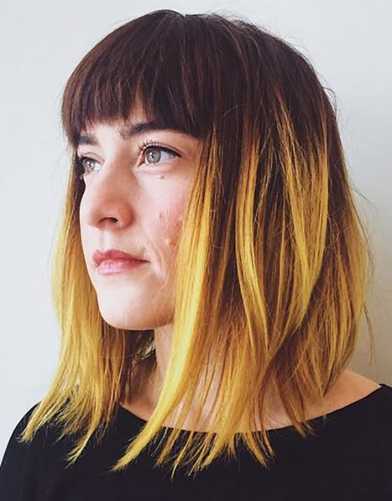 Bright yellow ombre with bangs for a fun and quirky look