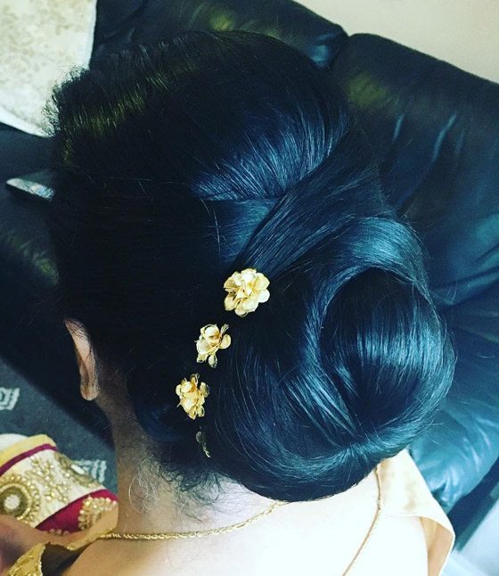 Criss cross flower accented bun Indian bridal hairstyle