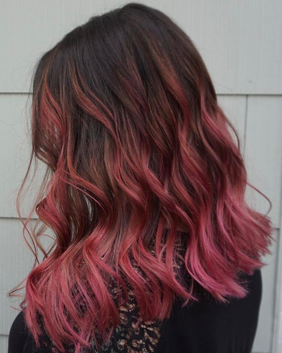 Dusty pink ombre hair color on blunt edged curls for a flirtatiously feminine look