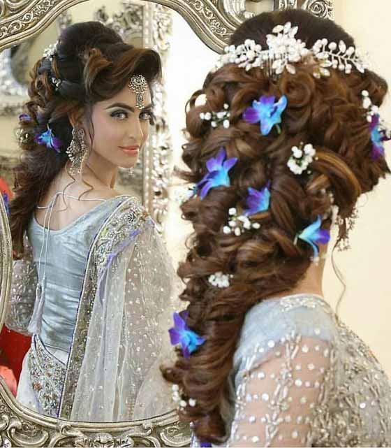 Floral curly fishtail braid Indian bridal hairstyle