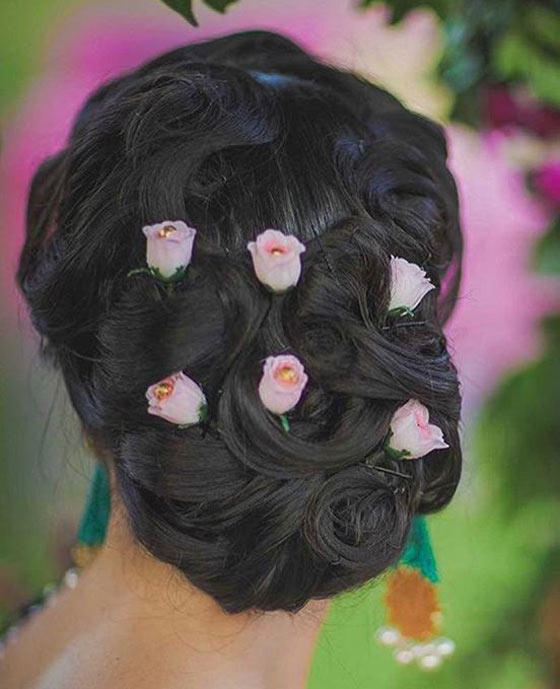 Rosy ringlet bun Indian bridal hairstyle