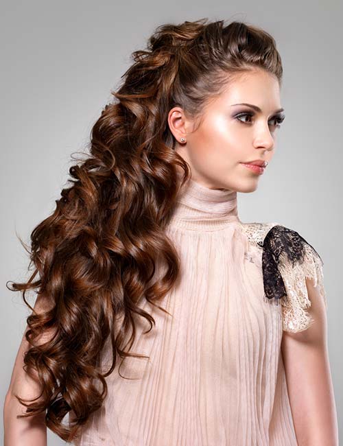Voluminous half updo curly long hairstyle
